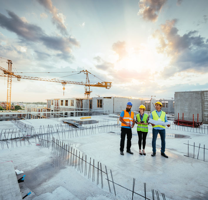 three people overseeing a construction project